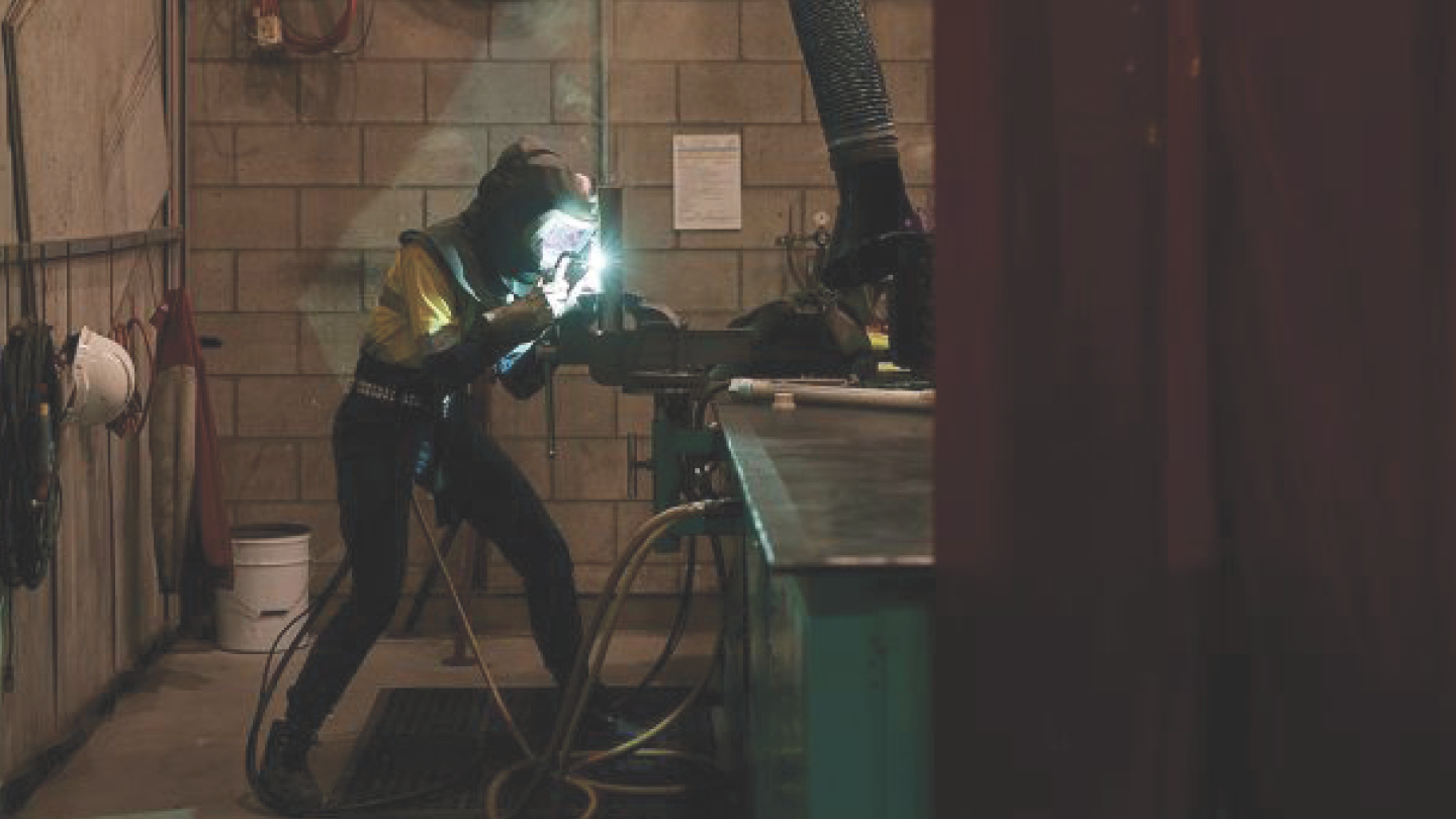 Worker welding submarine components