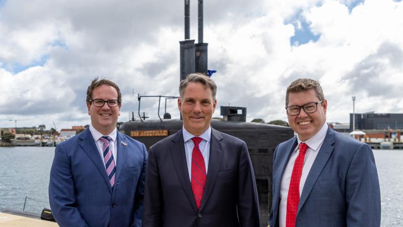 From left, Defence Personnel Minister Matt Keogh, Defence Minister Richard Marles and Defence Industry Minister Pat Conroy stand beside United States Navy submarine USS Asheville during a visit to HMAS Stirling, Western Australia. Photo: Leading Seaman Ernesto Sanchez