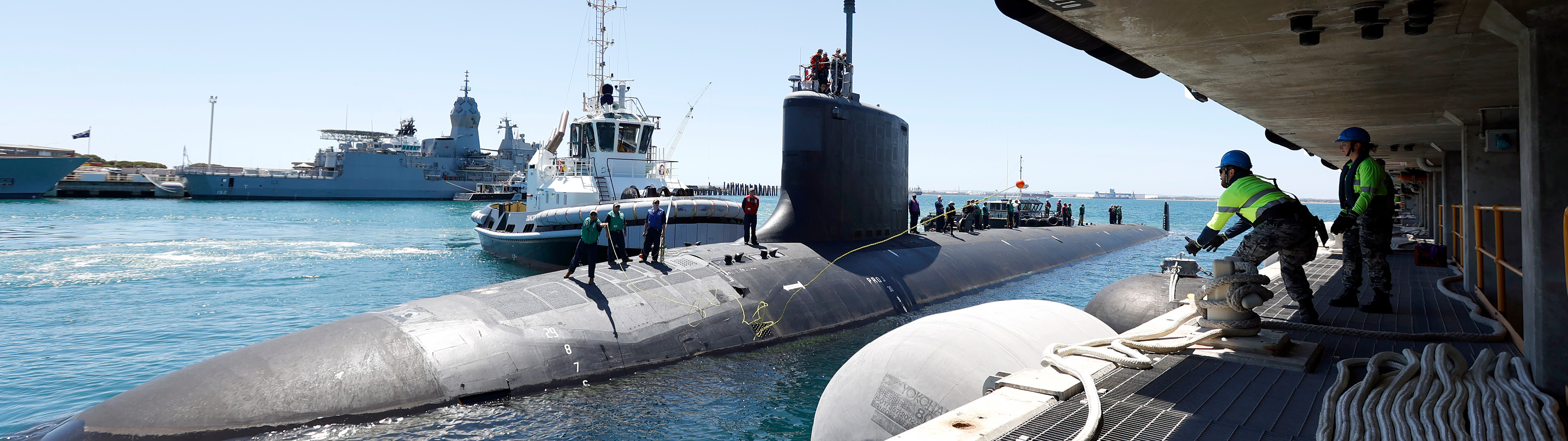 Submarine at port with people working on it