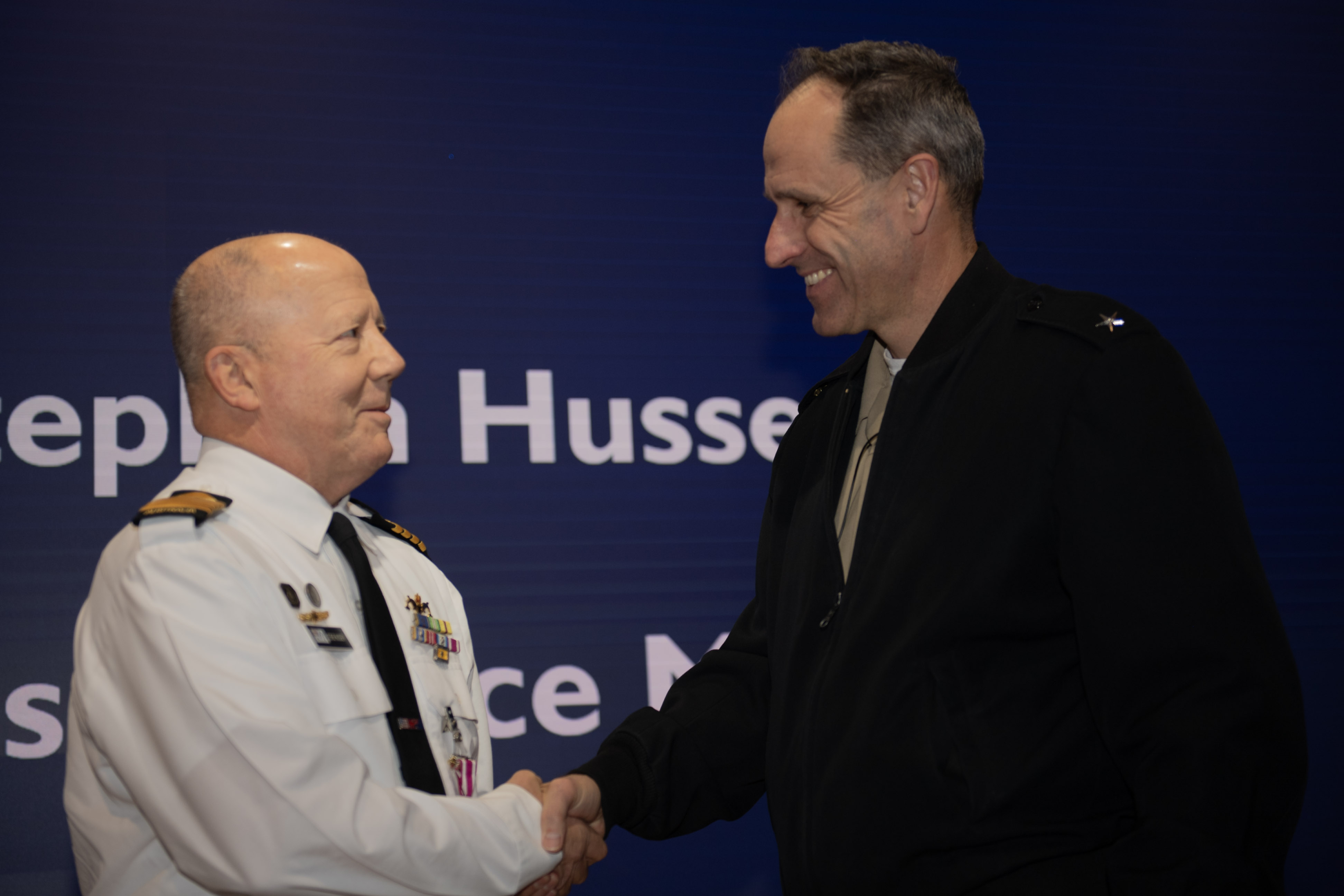 On behalf of the Secretary of the Navy, AUKUS Integration & Acquisition Director Rear Adm. Lincoln Reifsteck, right, presented Royal Australian Navy Captain Stephen Hussey with a Meritorious Service Award and medal during a Dec. 13, 2024